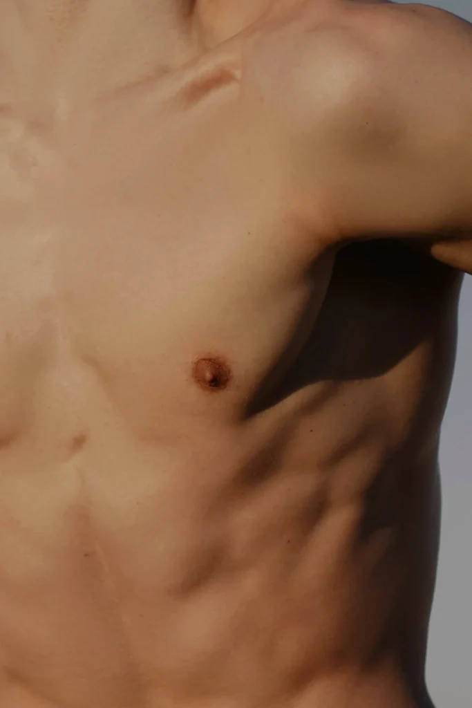 Close-up of abdomen in natural light, reflecting strength and vitality