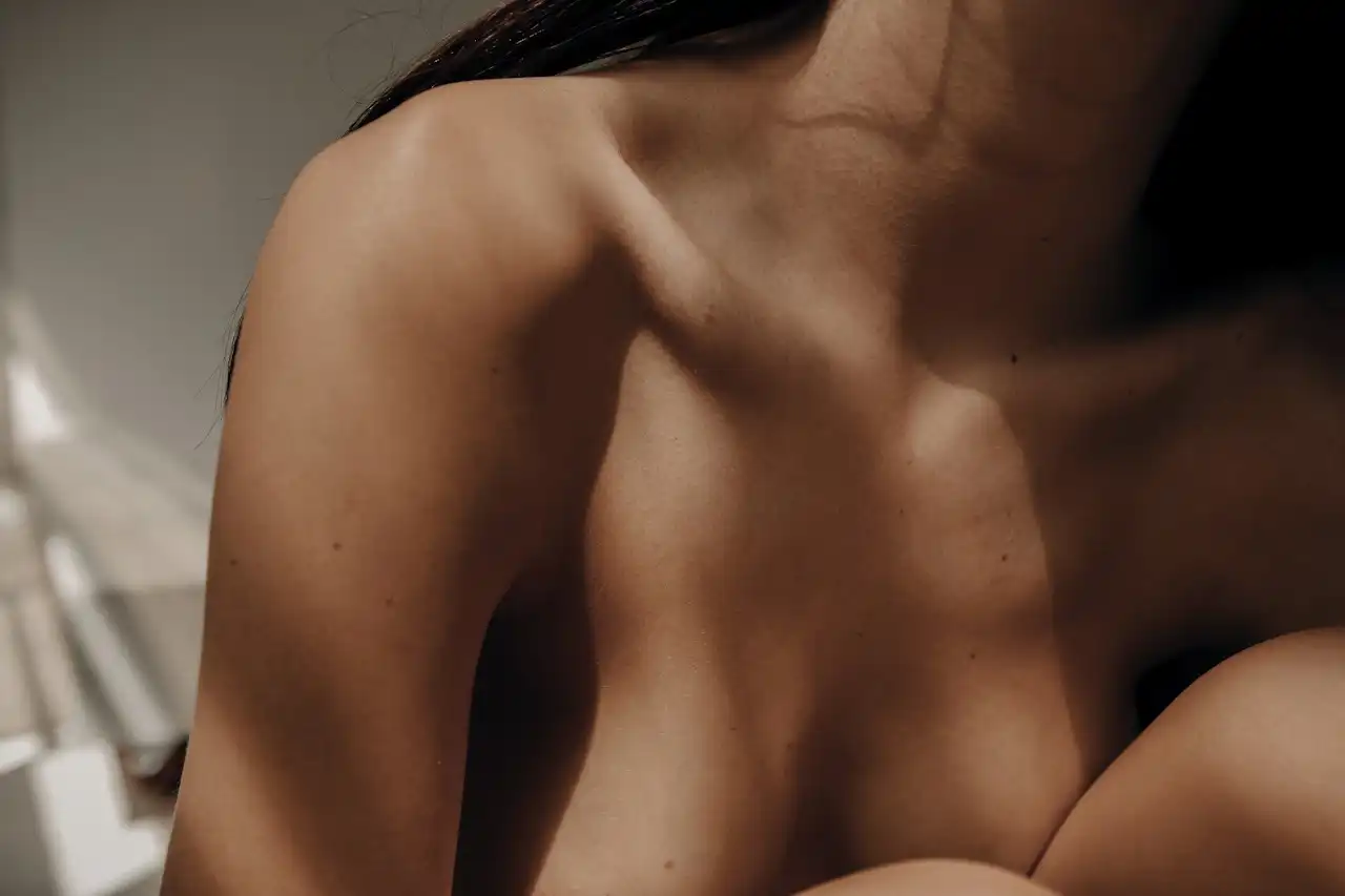Close-up of collarbone and shoulder in soft light, reflecting vitality and balance
